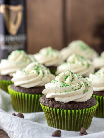 Irish Car Bomb cupcakes on white dish towel with Guinness beef in background