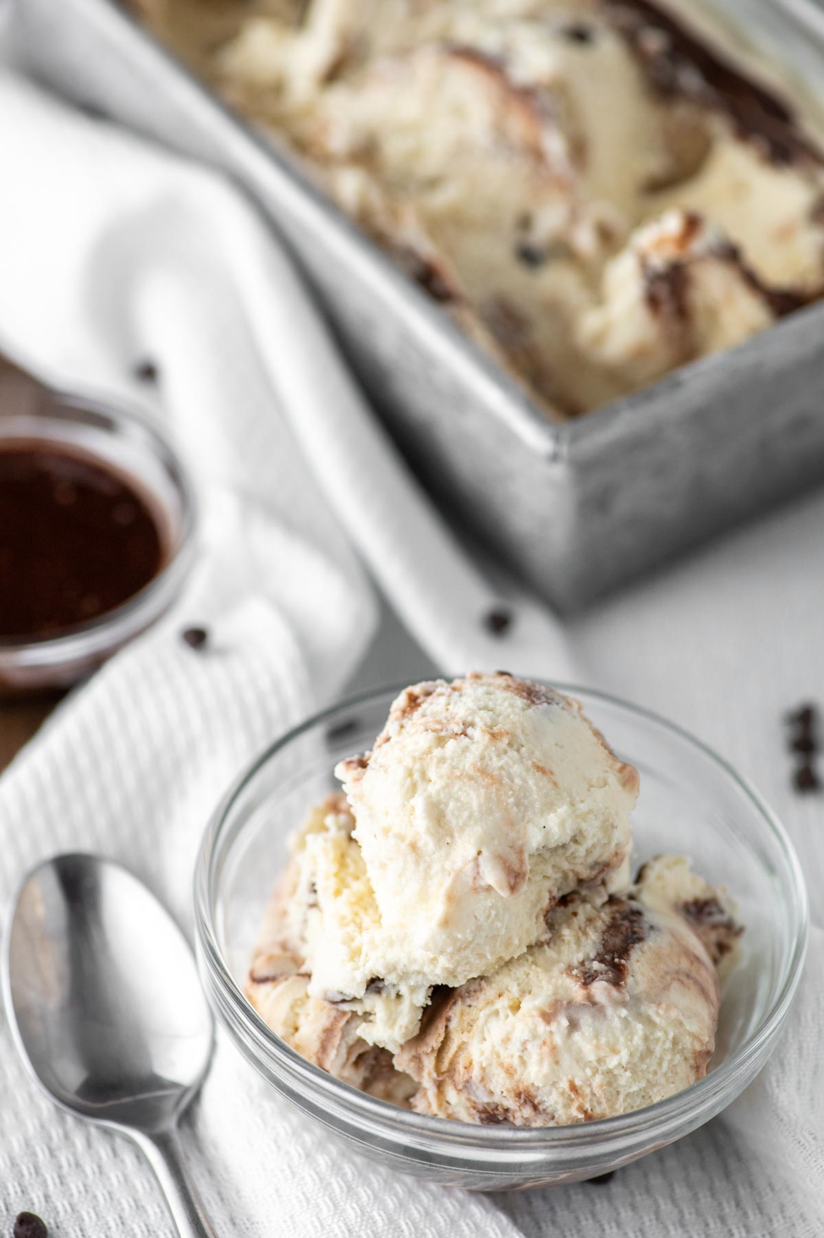 malted cookie dough ice cream in glass bowl and loaf pan in background