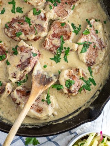 overhead shot of pork medallions in blue cheese sauce in skillet