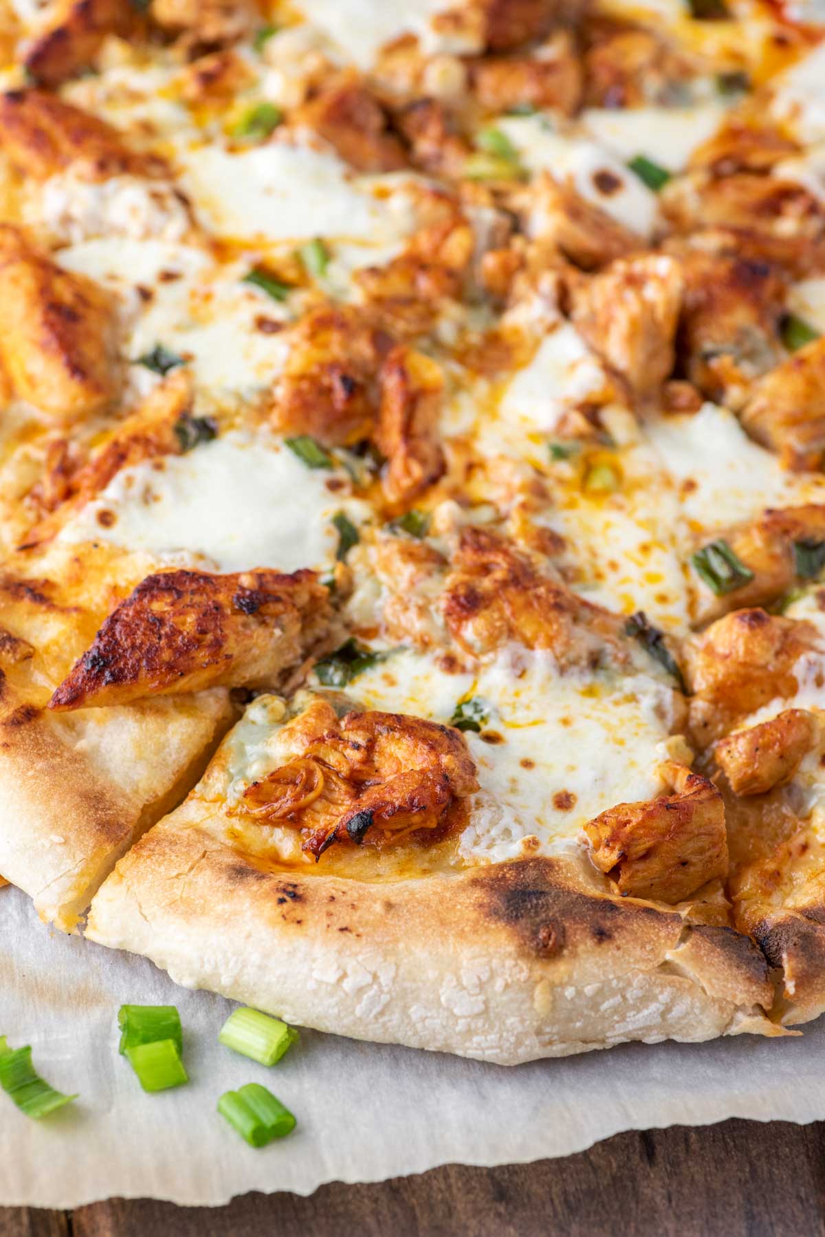 buffalo chicken pizza on parchment paper