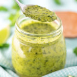 spooning out cilantro lime vinaigrette from jar