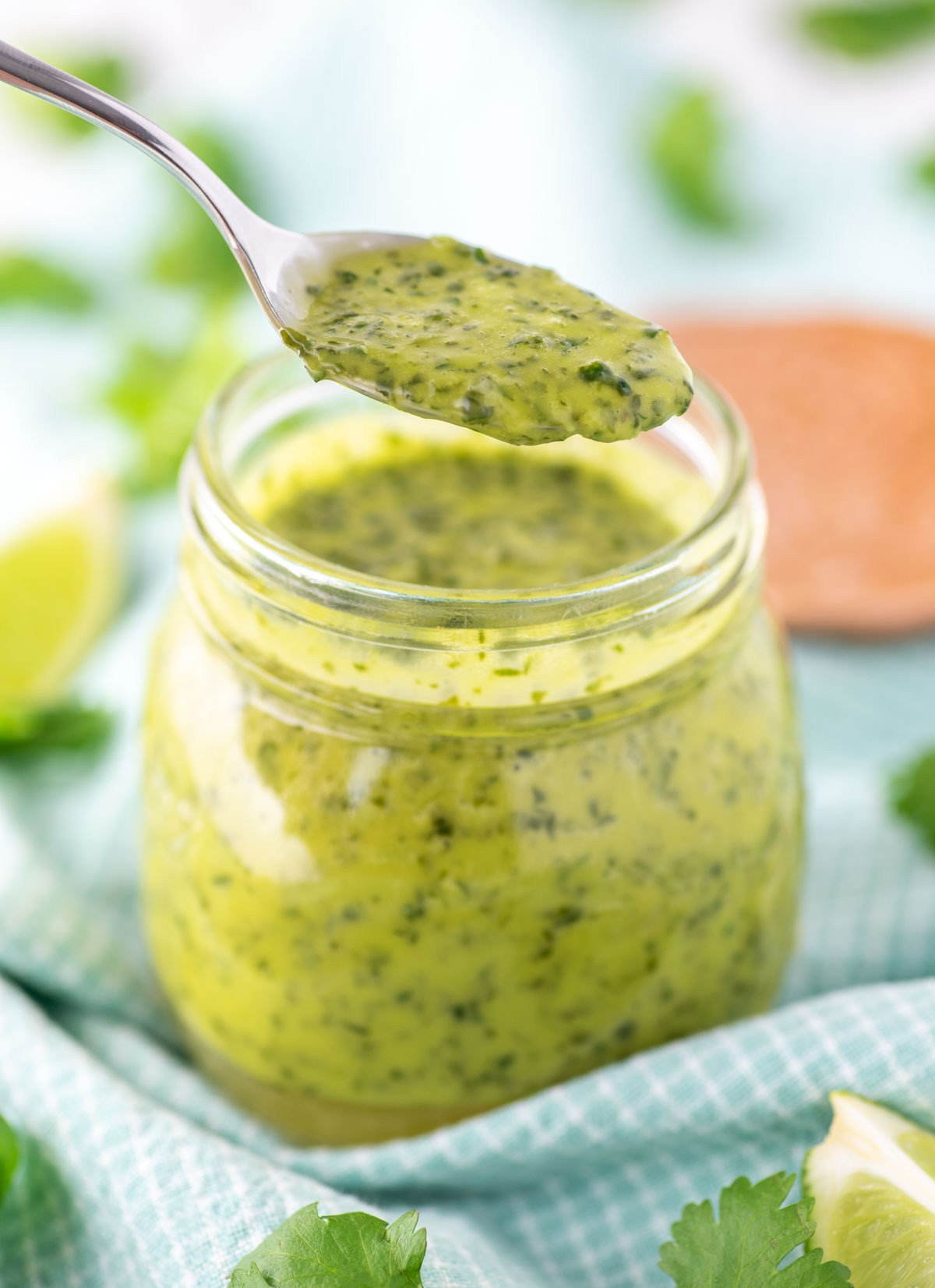 spooning out cilantro lime vinaigrette from jar