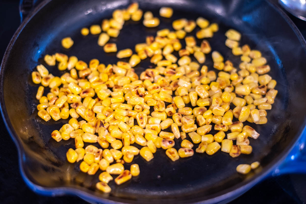 process shot of sauteing corn in skillet