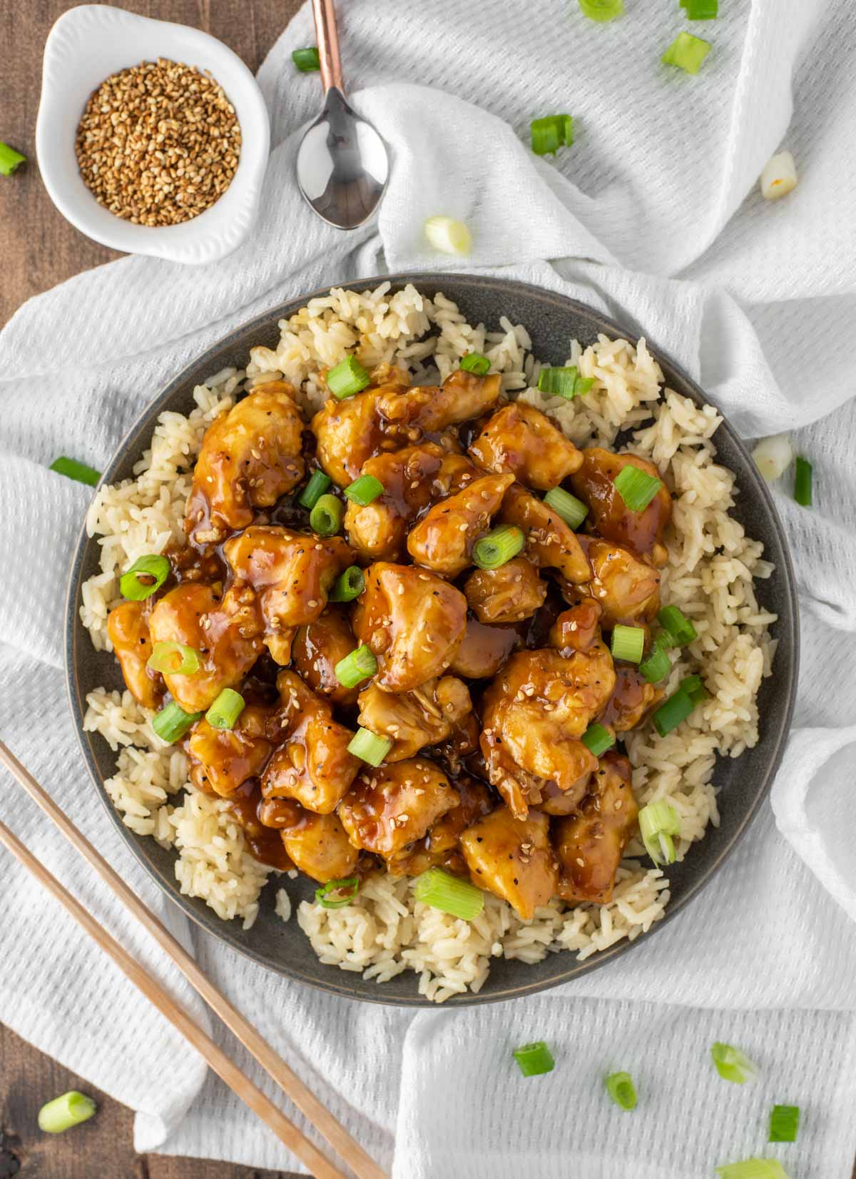 overhead shot of Chinese orange chicken on slate gray plate on dish towel