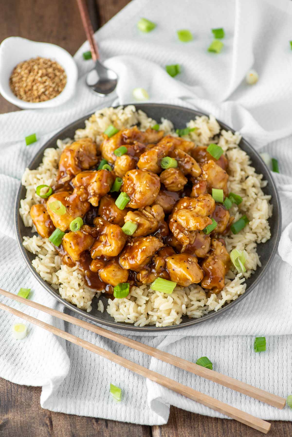 Chinese orange chicken on slate gray plate on dish towel