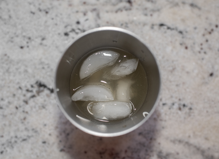 apple cider, vodka and lemon juice in cocktail shaker with ice