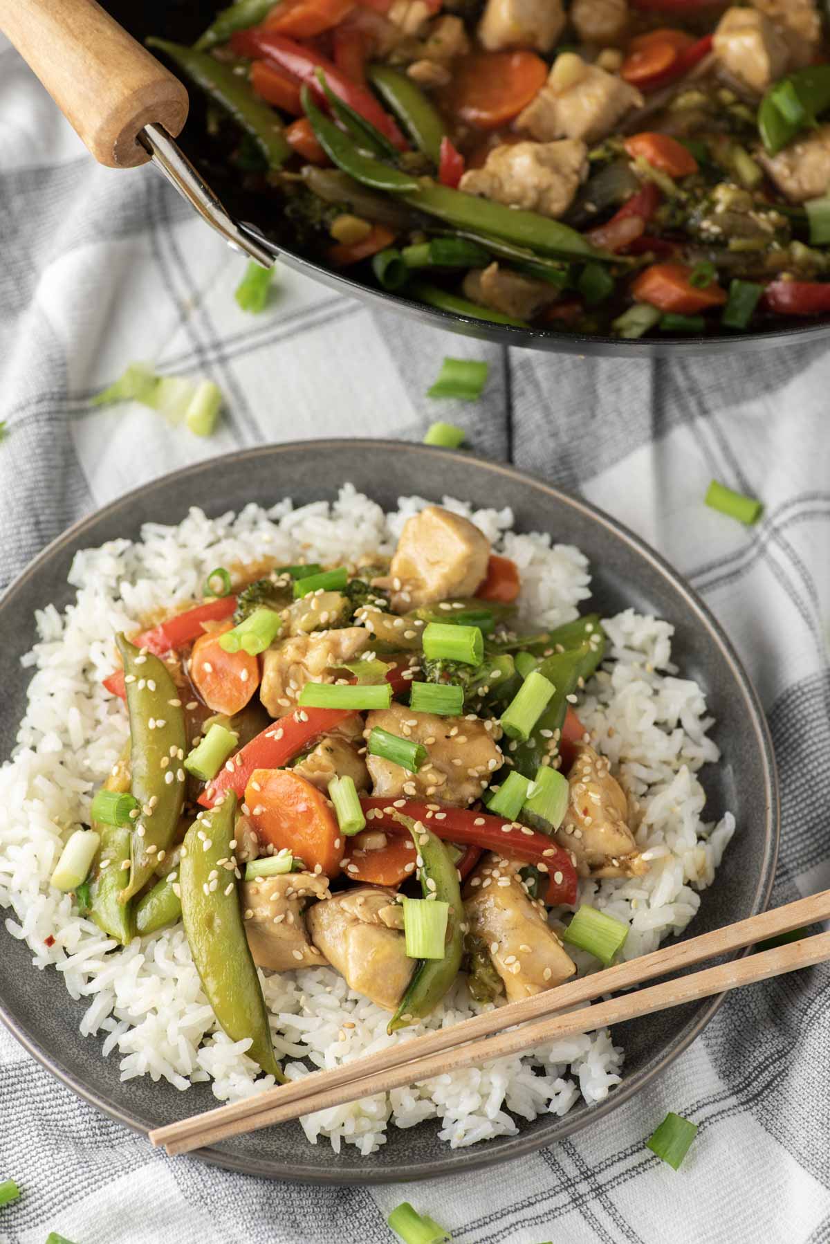 chicken and veggie stir fry over rice on dish towel
