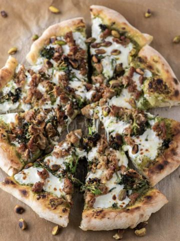 slices of broccoli rabe pizza on parchment paper