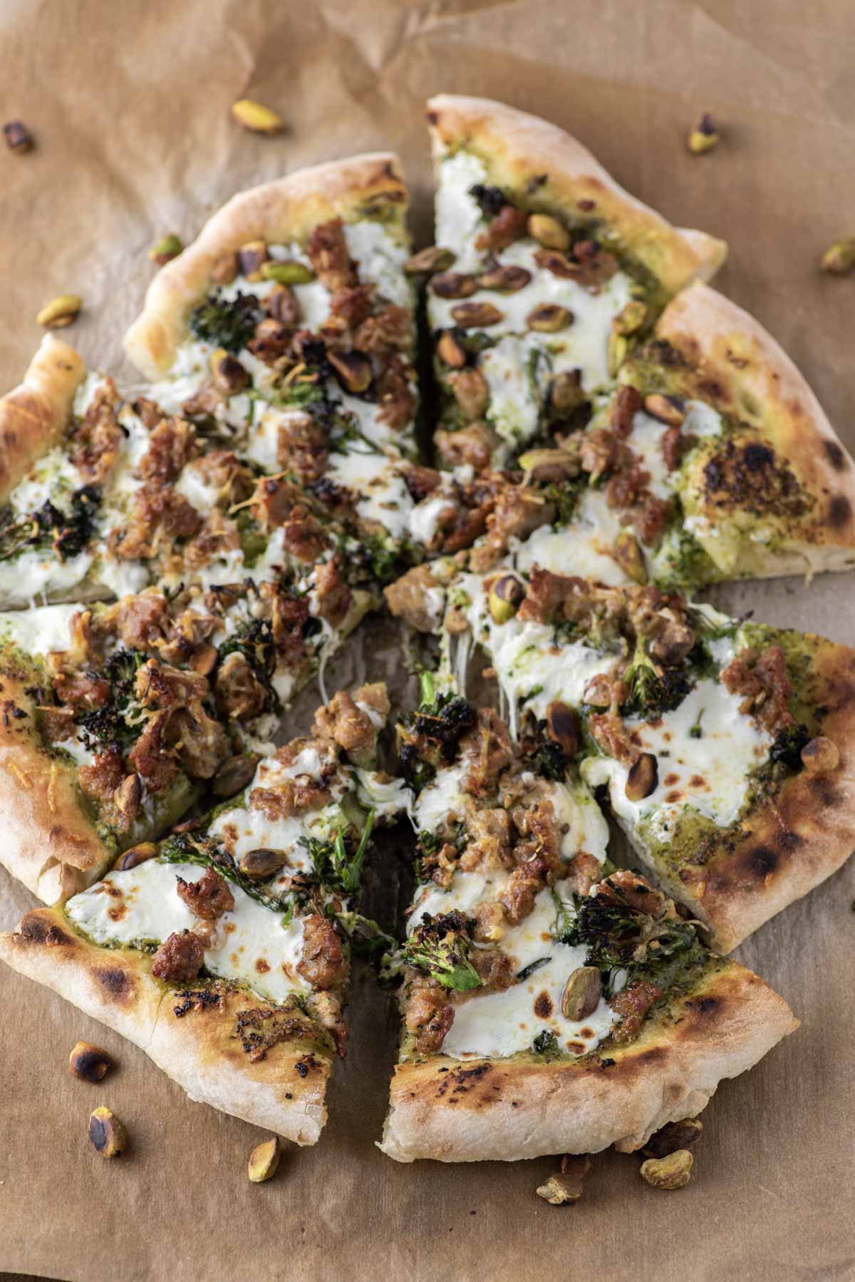 slices of broccoli rabe pizza on parchment paper