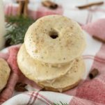 three eggnog donuts stacked on dish towel