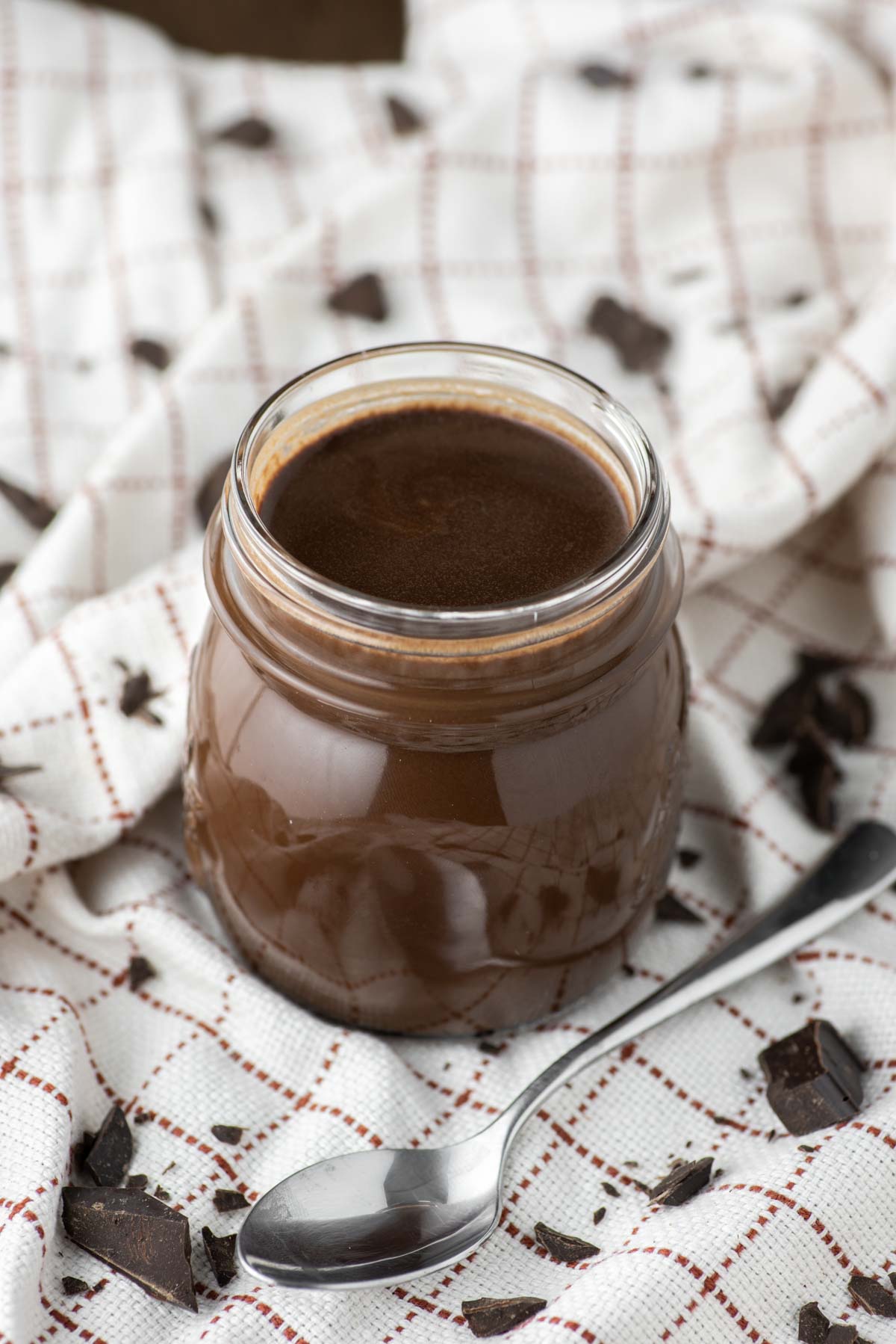 chocolate syrup in glass jar on dish towel