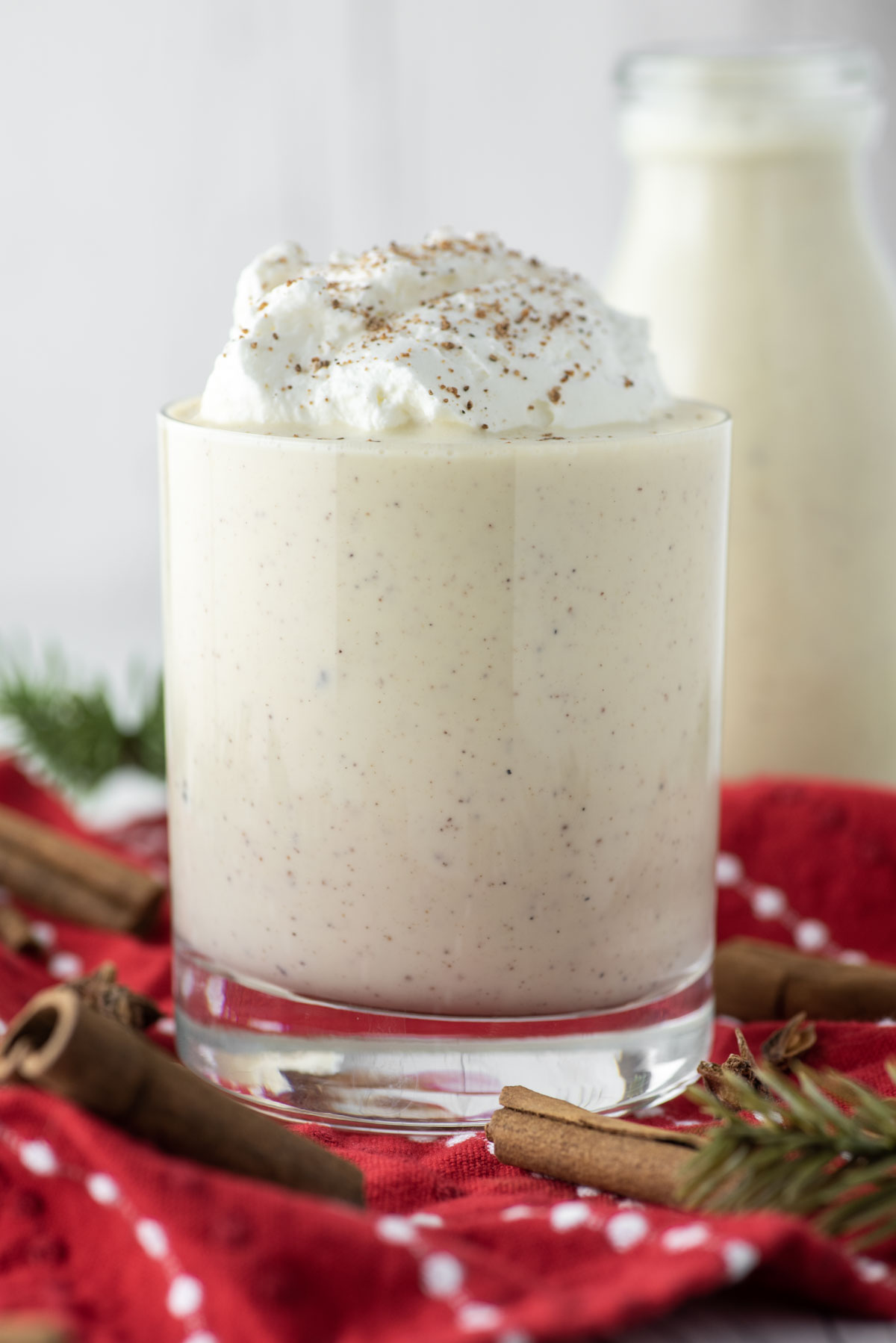 homemade eggnog in glass with whipped cream
