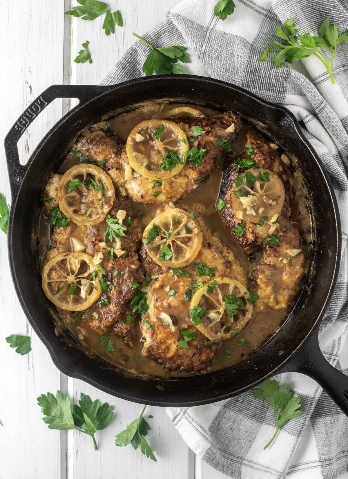 overhead shot of chicken francese in cast iron skillet