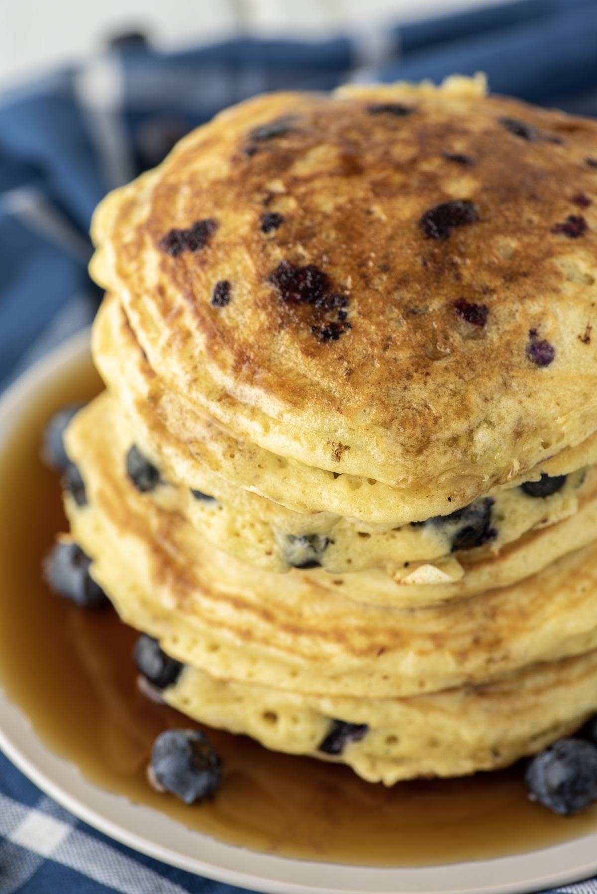 maple syrup on stacked blueberry pancakes