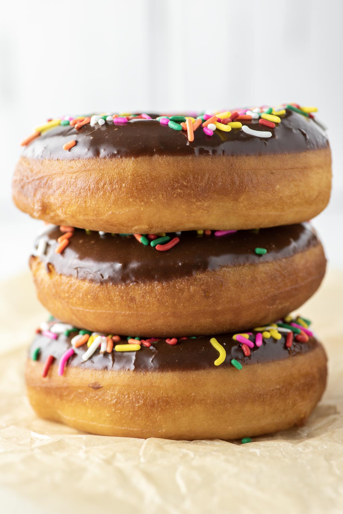 3 chocolate frosted donuts stacked