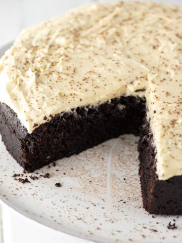 sliced Guinness chocolate cake on white cake stand