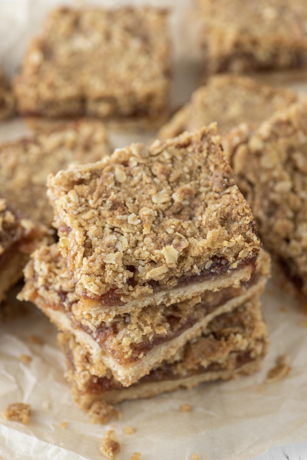 jam bars stacked on top of each other on parchment paper