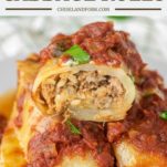 stuffed cabbage roll cut in half and stacked on two cabbage rolls