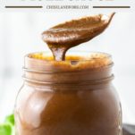 spoon dipped in glass jar with mole sauce