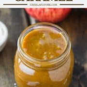 caramel sauce in glass jar with apples in background