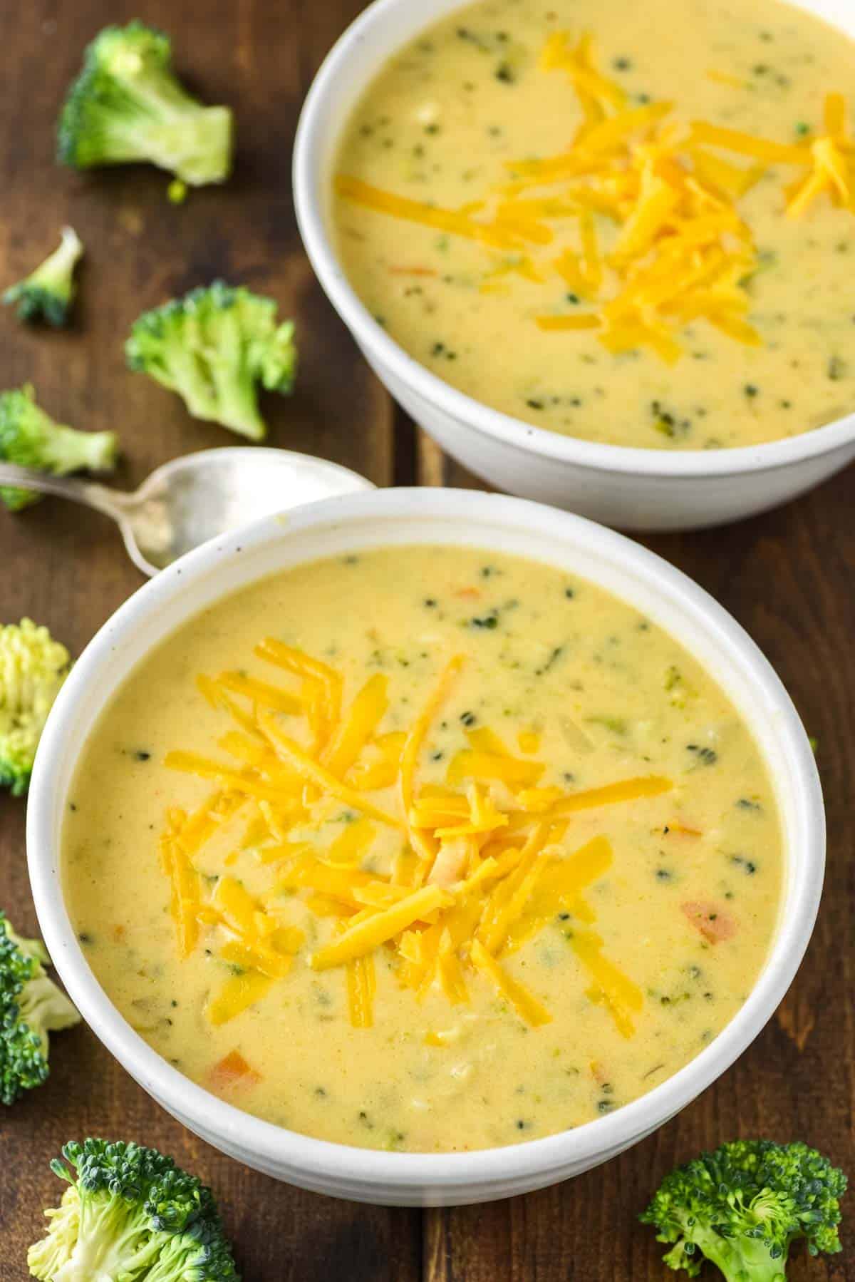 two speckled bowls of broccoli cheese soup