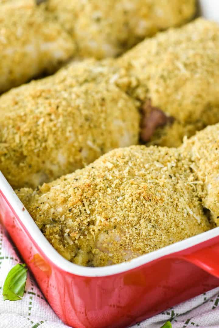 chicken rolled in breadcrumbs in red baking dish