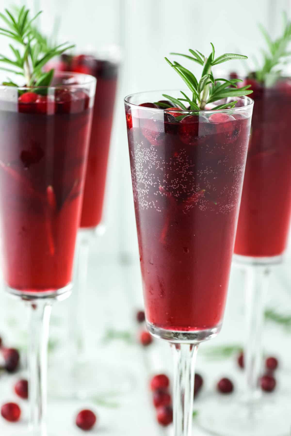 4 glasses of mimosas with cranberries