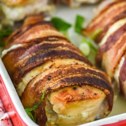 bacon wrapped stuffed chicken in red baking dish