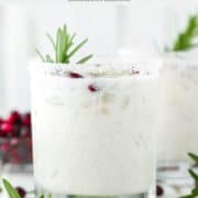 glass of margarita with coconut, rosemary and pomegranate seeds
