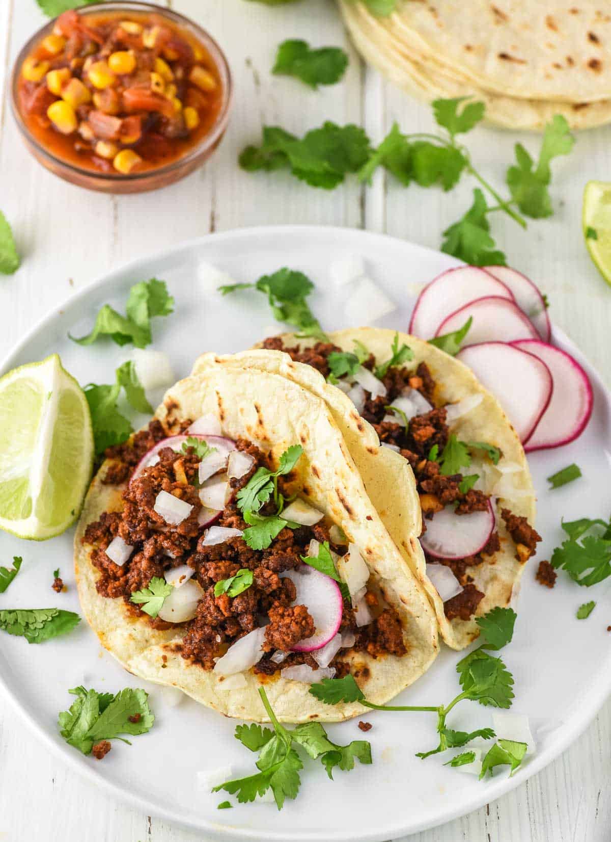 two tacos with homemade chorizo on white plate