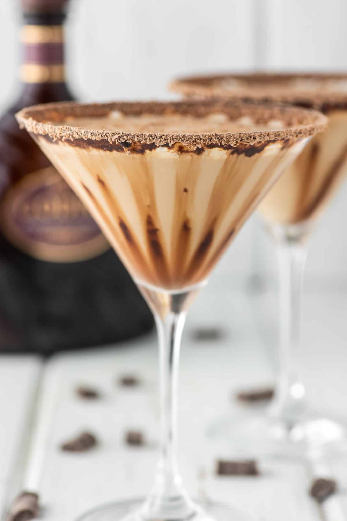 two glasses of Godiva chocolate martinis with Godiva liqueur in the background