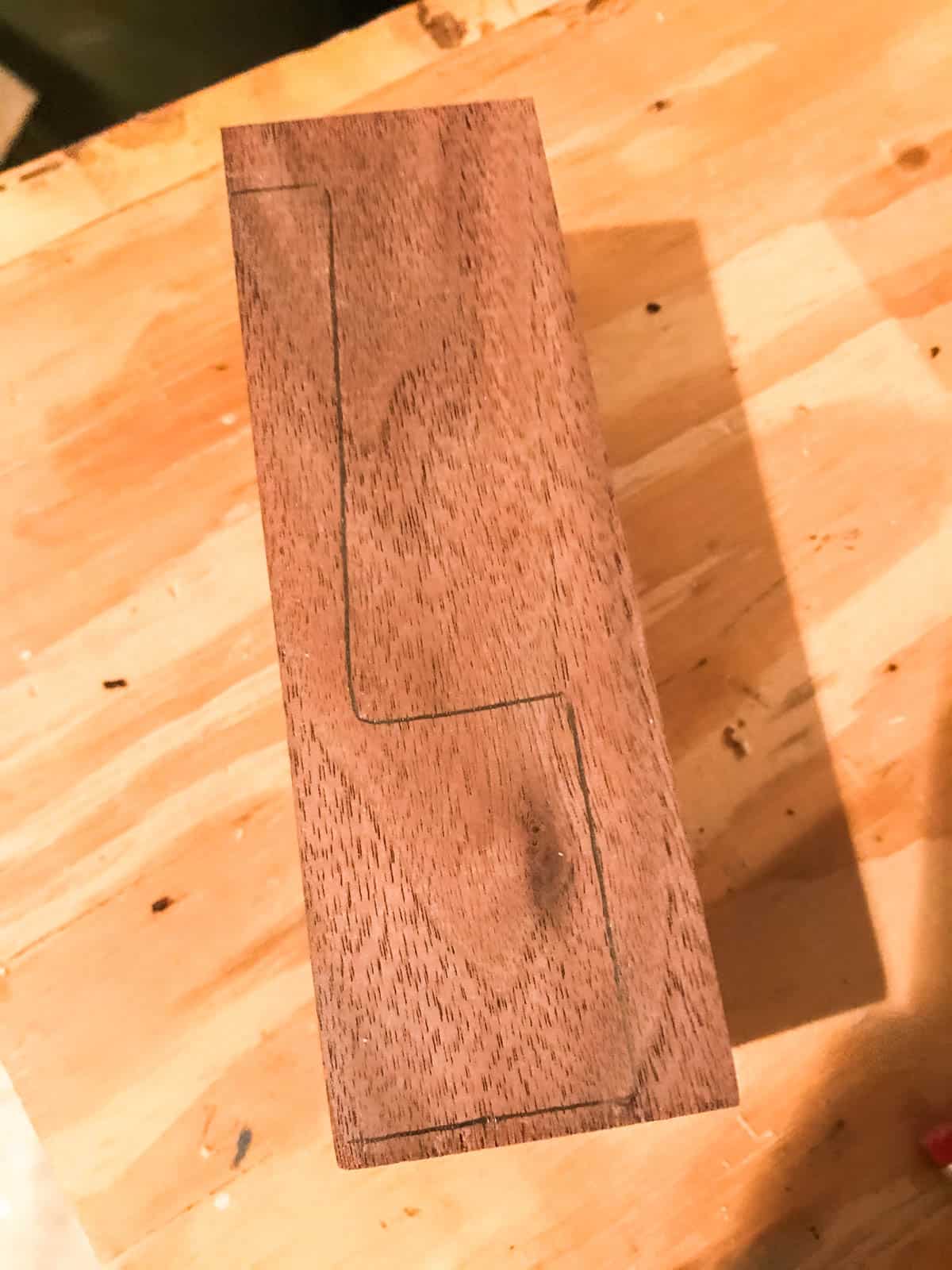 drawing side profile of coffee scoop on wood