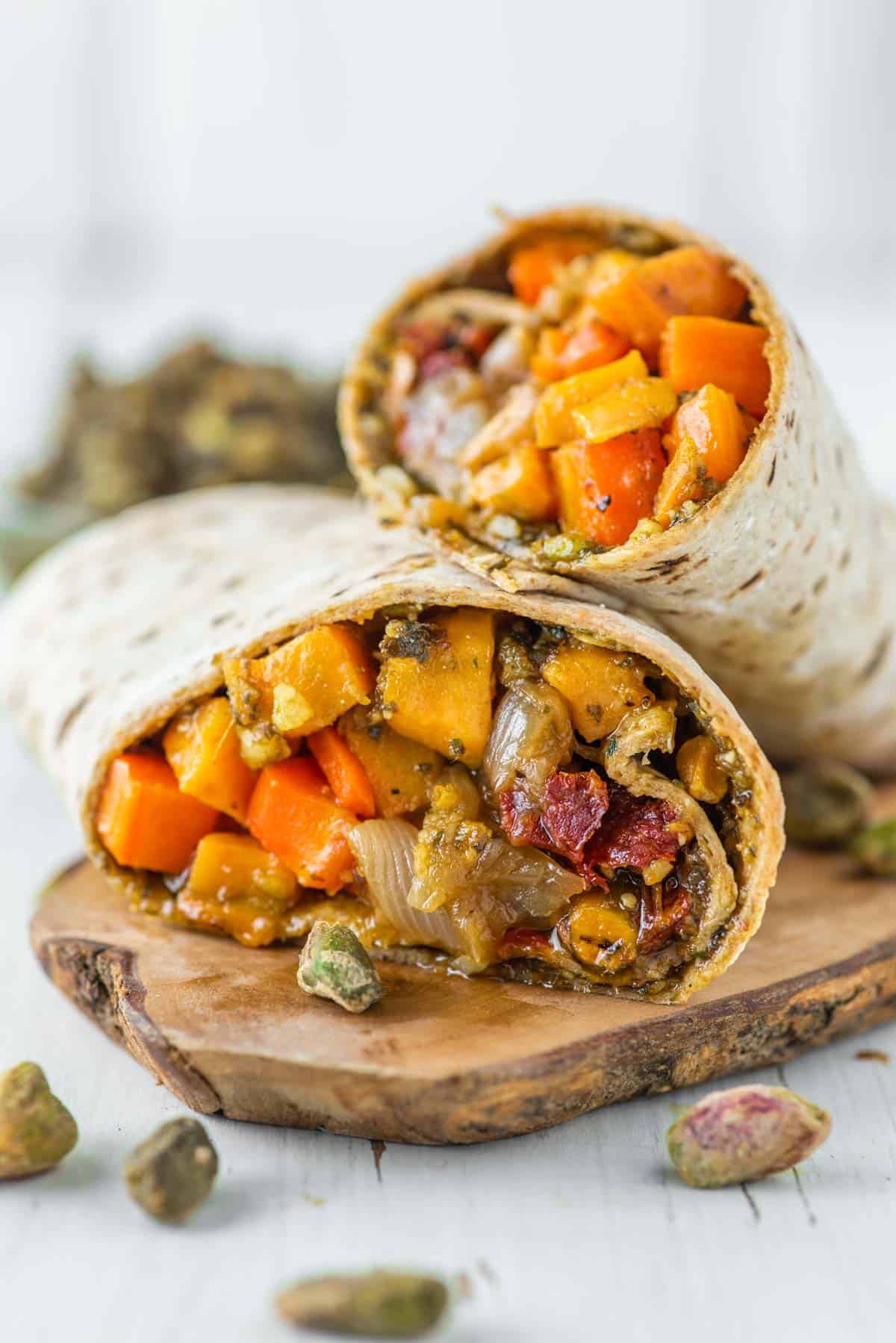 wrap with roasted sweet potatoes and caramelized onions on wood board