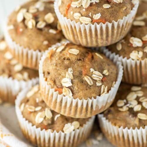 stacked banana carrot muffins with oats on plate