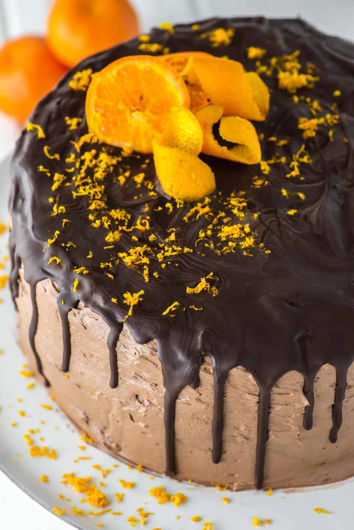 chocolate orange drip cake on white stand