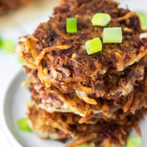 corned beef fritters stacked on white plate