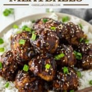 Asian turkey meatballs stacked on top of plate with rice