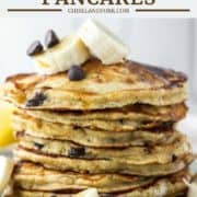 stacked pancakes with bananas and chocolate chips on plate
