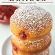 donuts filled with jam stacked on a plate