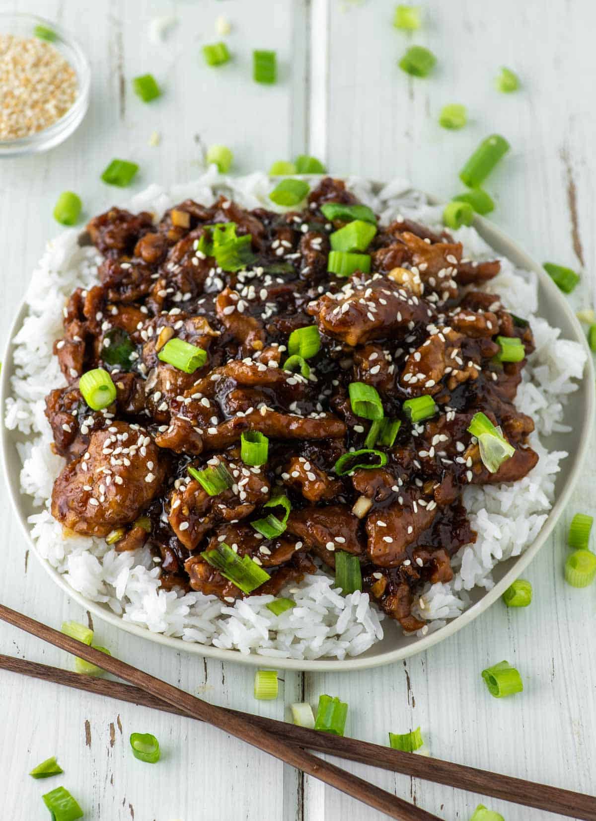 Mongolian pork on bed of rice on plate