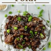Mongolian pork on bed of rice on plate