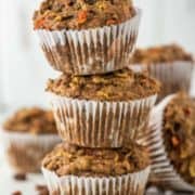 3 stacked morning glory muffins with more in background