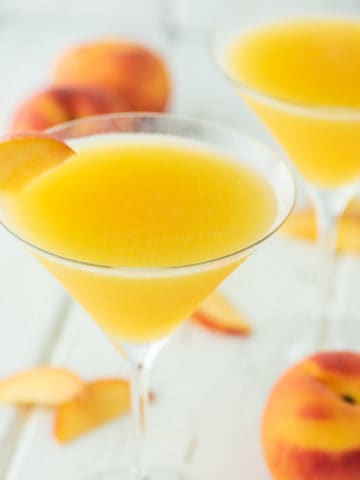 two glasses of martinis with fresh peaches