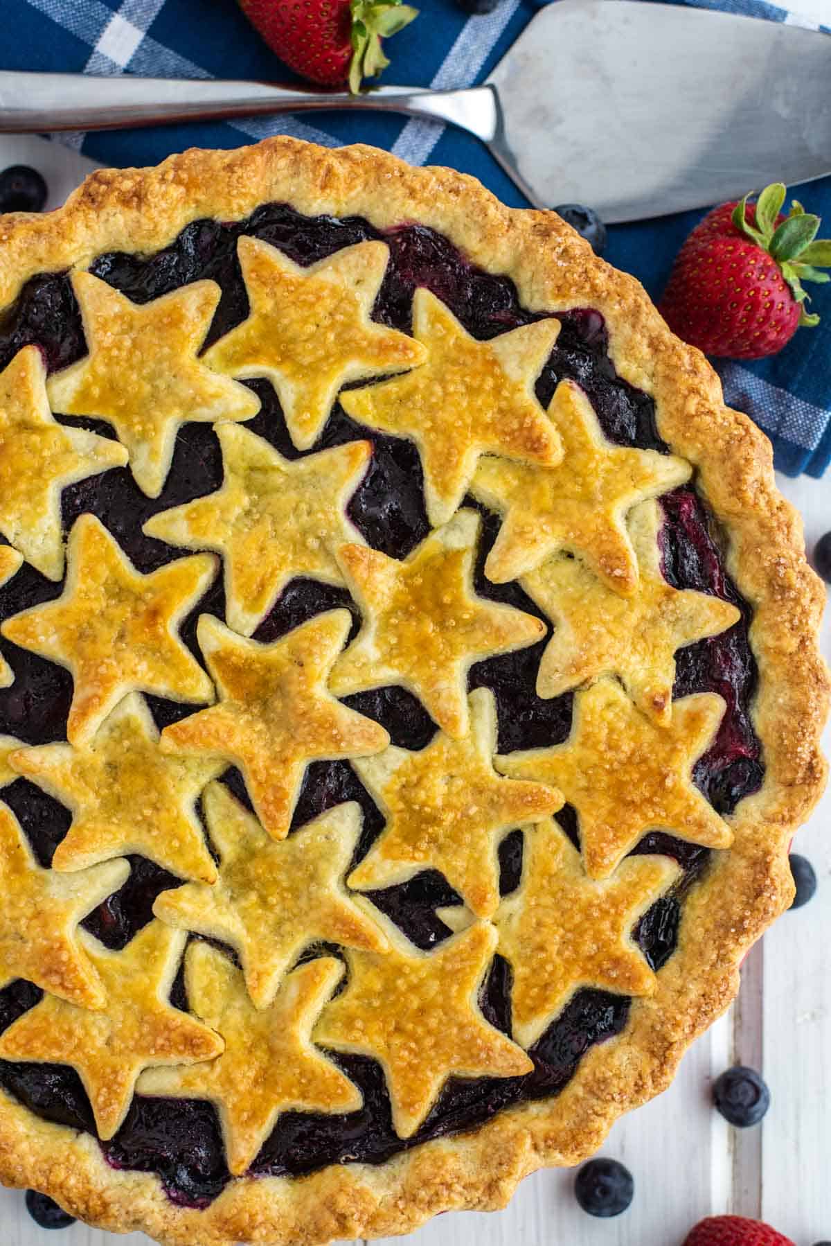 overhead shot of mixed berry pie with stars in pie plate