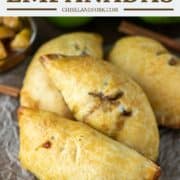 empanadas filled with apples on parchment paper