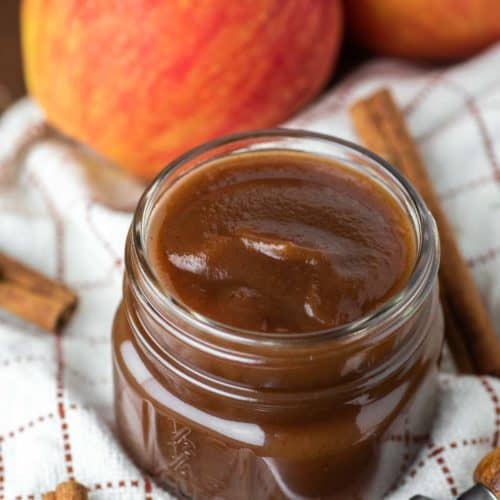 apple butter in glass jar on dish towel
