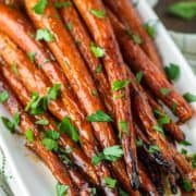 close-up of maple roasted carrots on white plate