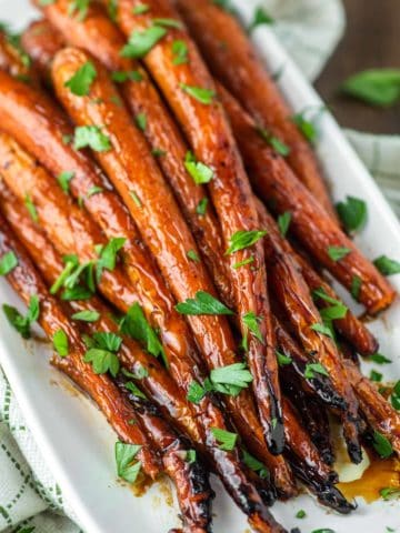 close-up of maple roasted carrots on white plate