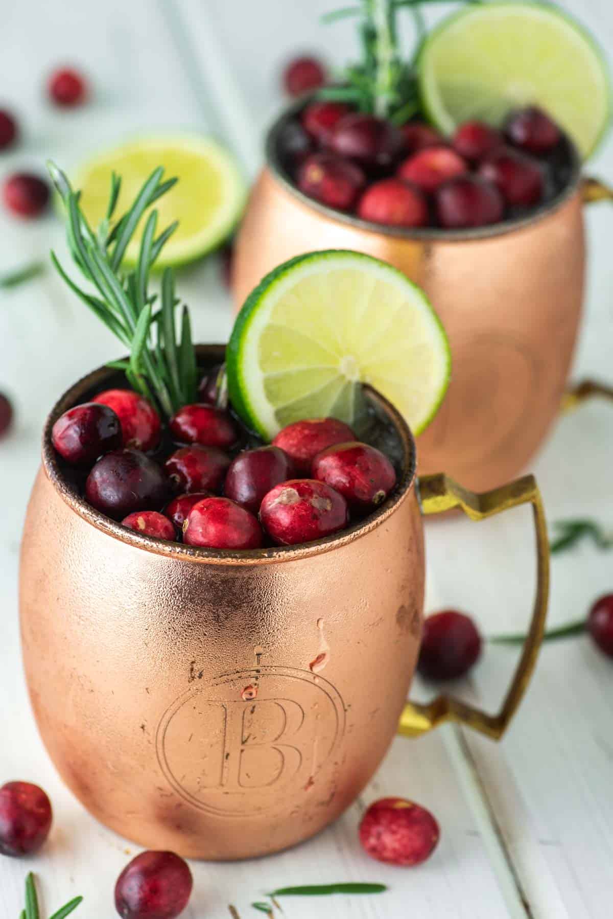 two mugs of cranberry Moscow Mules