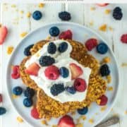 overhead shot of Captain Crunch French toast on plate with whipped cream and berries